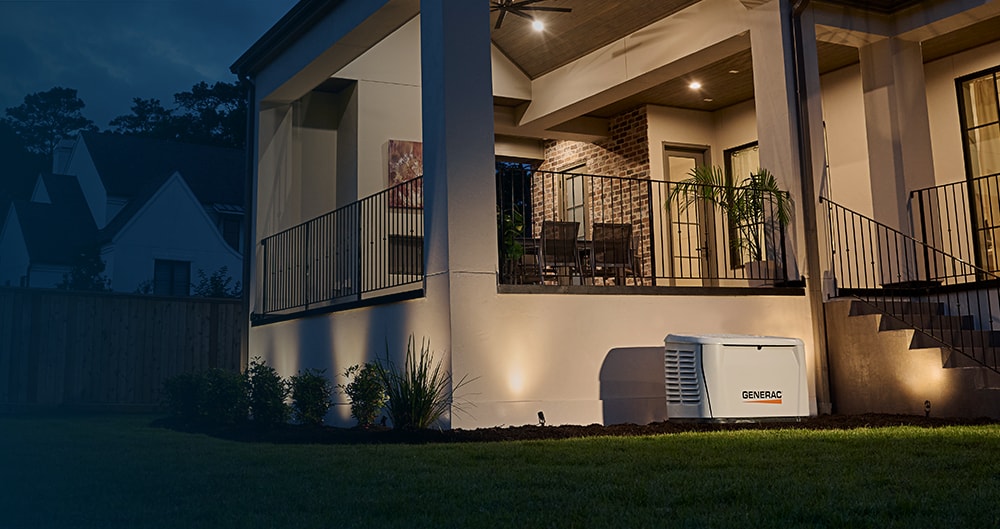 generac home generator installed next to a porch in the evening