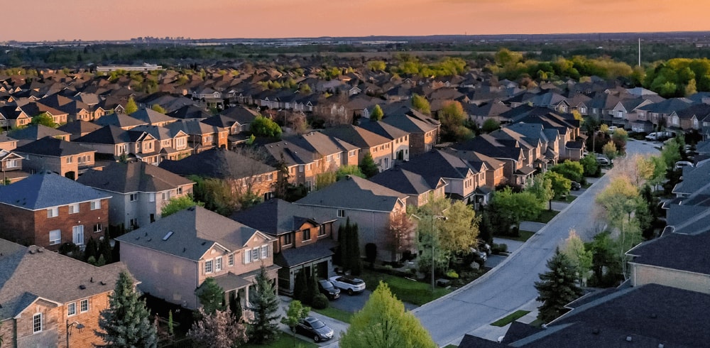 Neighborhood of houses in the suburbs during sunset.