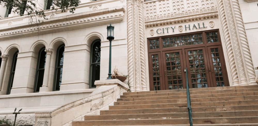 Front view of City hall entrance steps during the day.