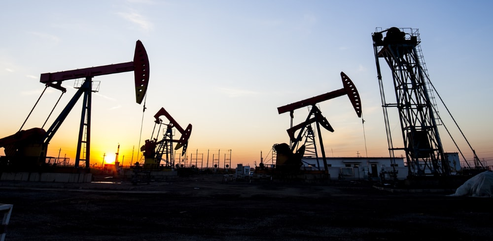 Oil field pumpjacks at sunset representing how Generac mobile gaseous generators power operations using wellhead gas for reliable, cost-effective energy