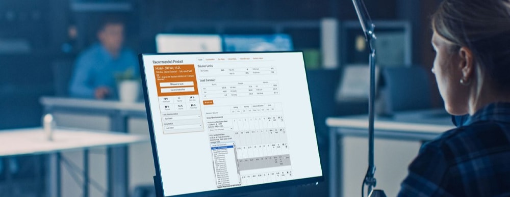 Woman using Power Design Pro on computer monitor.