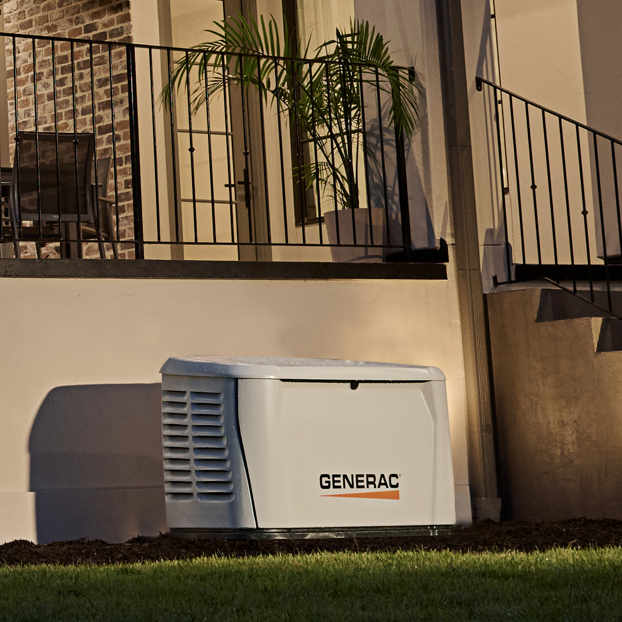 Generac home generator installed next to a home with the power on