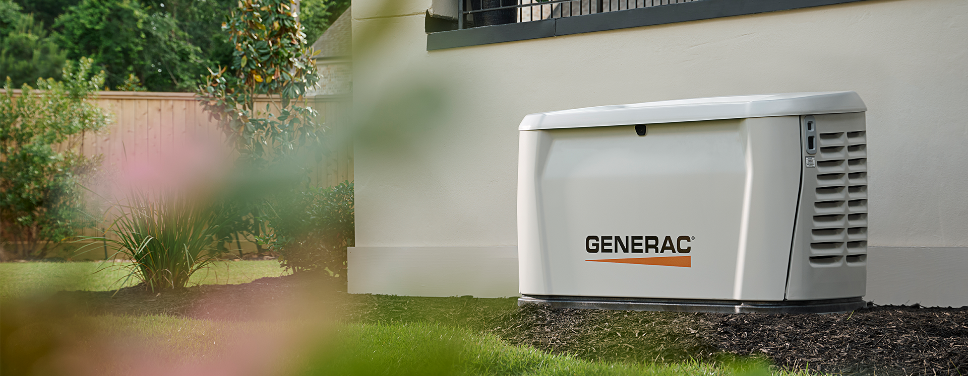 Generac home generator outside of a house on a sunny day 