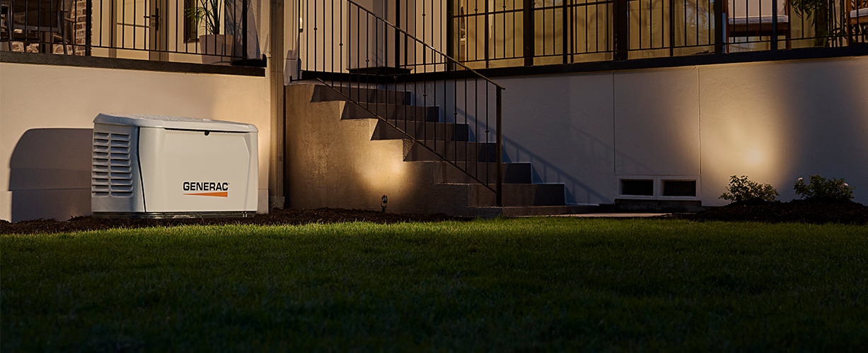 Generac home generator next to a home with the lights on