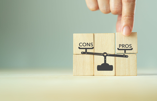 Image of blocks building a scale weighing pros and cons
