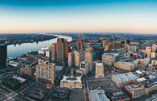 Image of the skline of Detroit Michigan showing both sides of the Detroit River. Windsor Canada in the distance