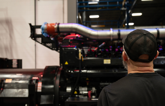 Generac Industrial Energy employee looking at a large mega watt data center generator