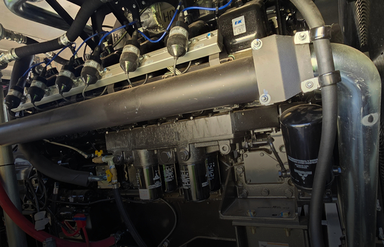 Close-up of a Generac industrial generator engine and fuel system components representing the different fuel options including diesel, natural gas, and Bi-Fuel™ solutions