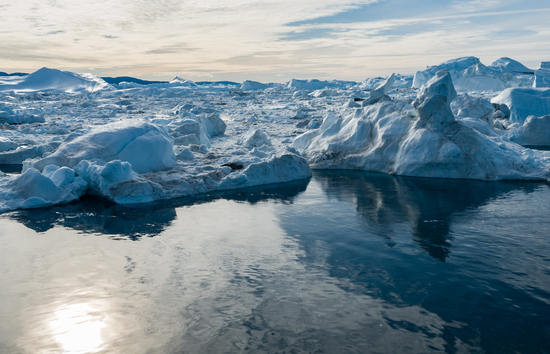 Polar ice caps melting into sea as a result of climate change