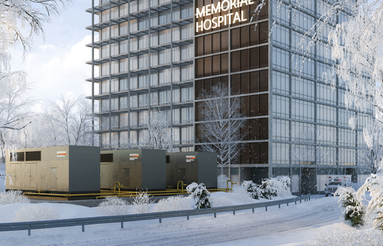 Three industrial natural gas generators outside of a hospital building during winter