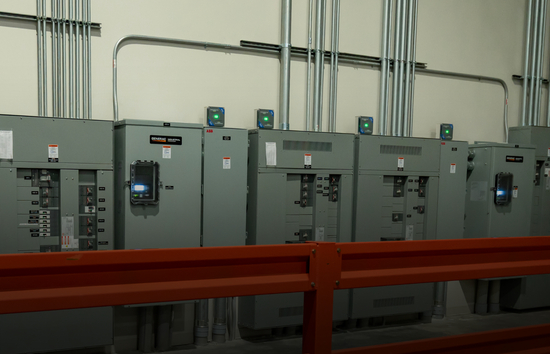 Industrial transfer switches in a facility using a Generac Industrial Energy generator representing insights from white papers on transfer switches, backup power systems, generator maintenance, and other in-depth considerations.