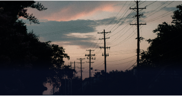 Powerlines in front of a stormy sunset