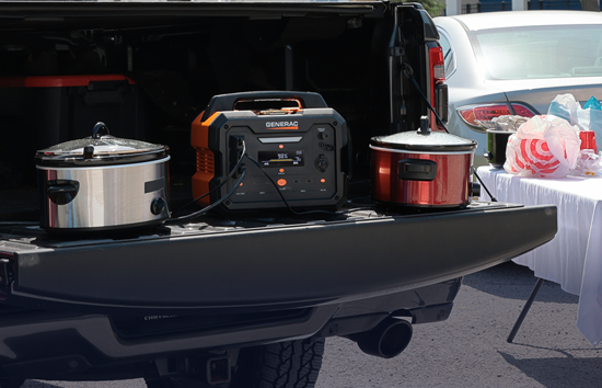 Generac portable power station powering slow cookers at a tailgate