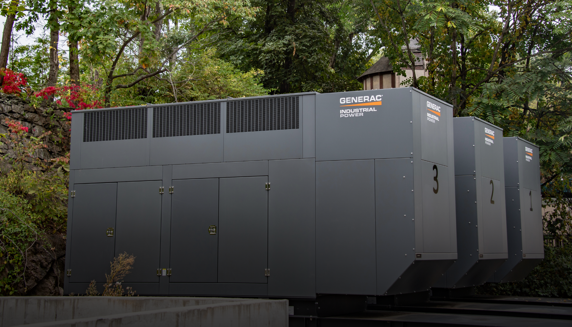 Outdoor installation of three Generac Industrial Energy modular generators, illustrating a real-world backup power solution For Sunshine Hospital in New York featured in Generac's library of case studies.