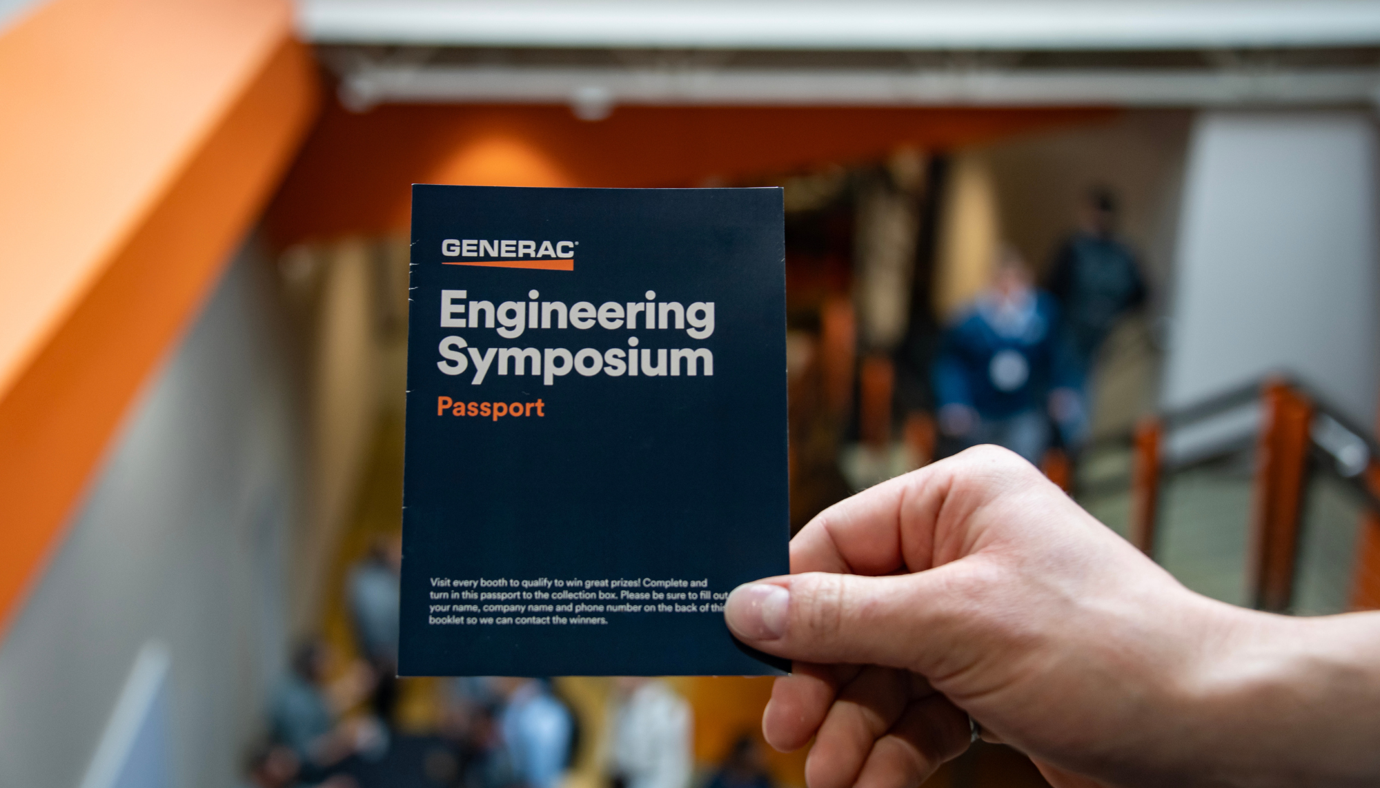A hand holds a passport booklet for Generac Industrial Energy's Engineering Symposium, a biannual conference returning September 21–23, 2025. This 3-day event features PDH- and CEU-accredited sessions on generator sizing, paralleling, and codes and standards, as well as facility tours and peer networking.