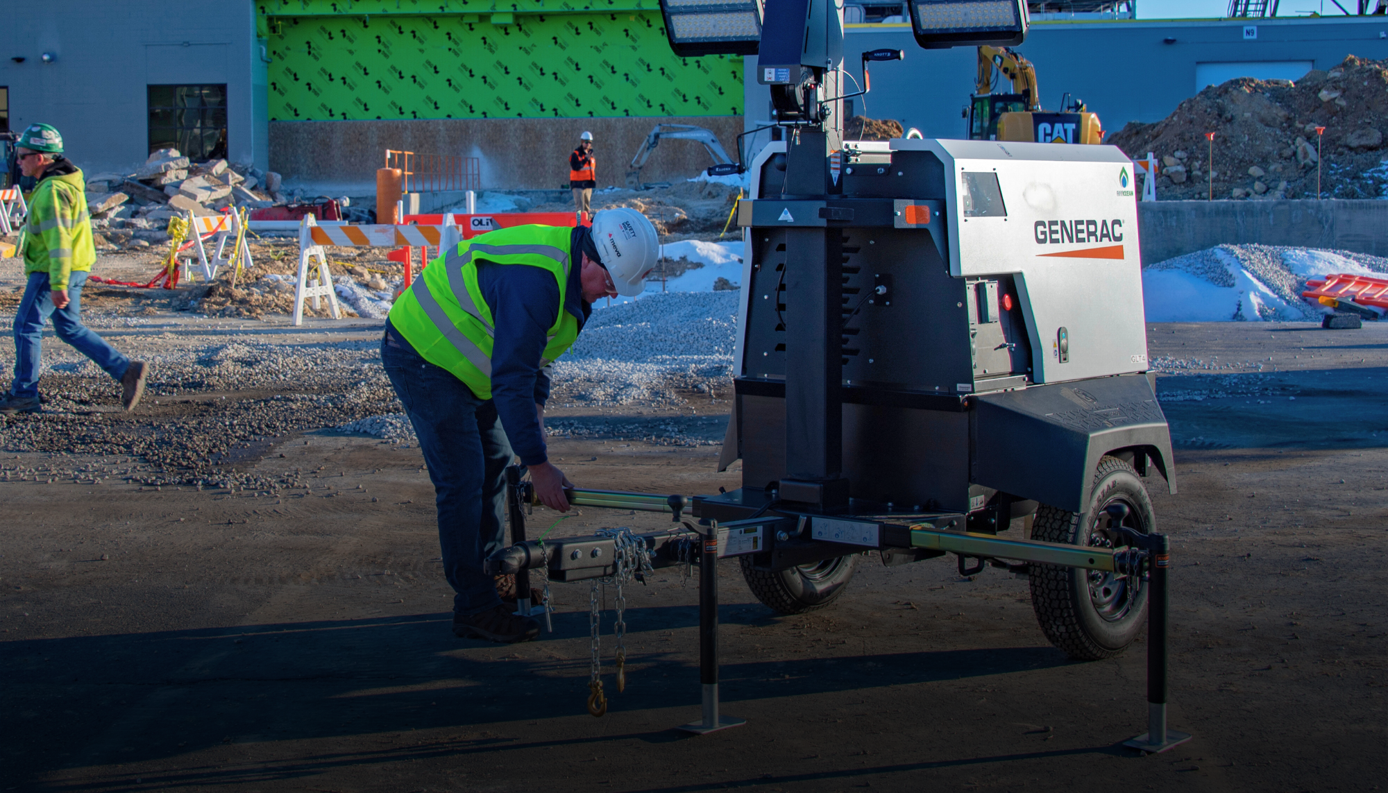 Technician securing mobile light tower at a construction site showing the value of having all Generac Light Tower manuals accessible for service, parts, and maintenance documentation