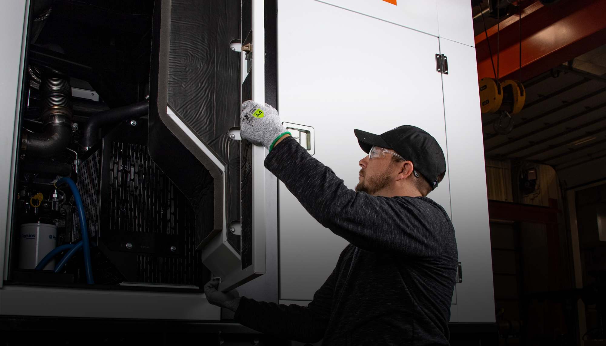 Technician performing routine maintenance on a Generac mobile generator. Access mobile generator manuals for service, troubleshooting, and dealer support.