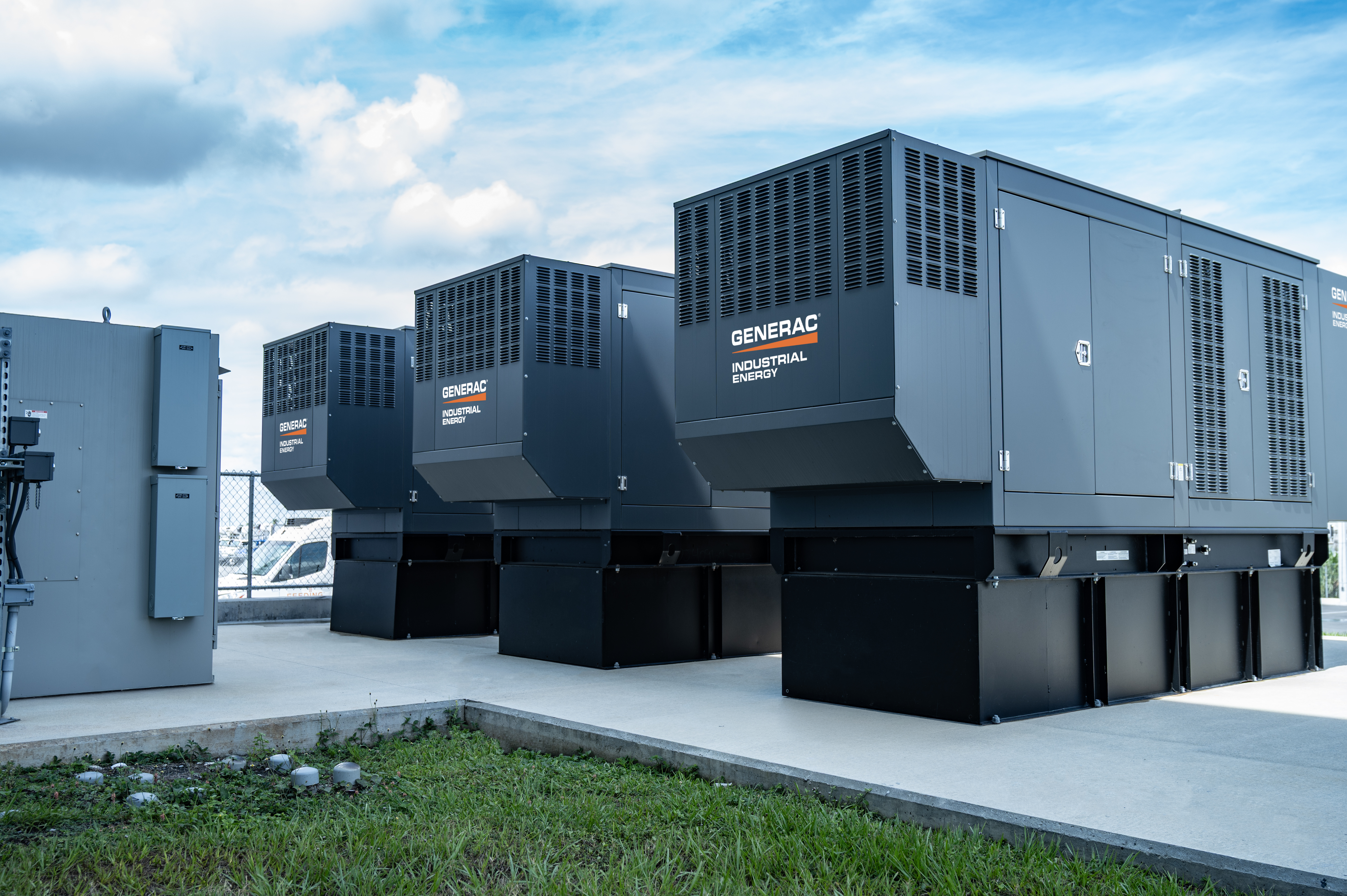 Three Industrial Generators with Switchgear on a Sunny Day 