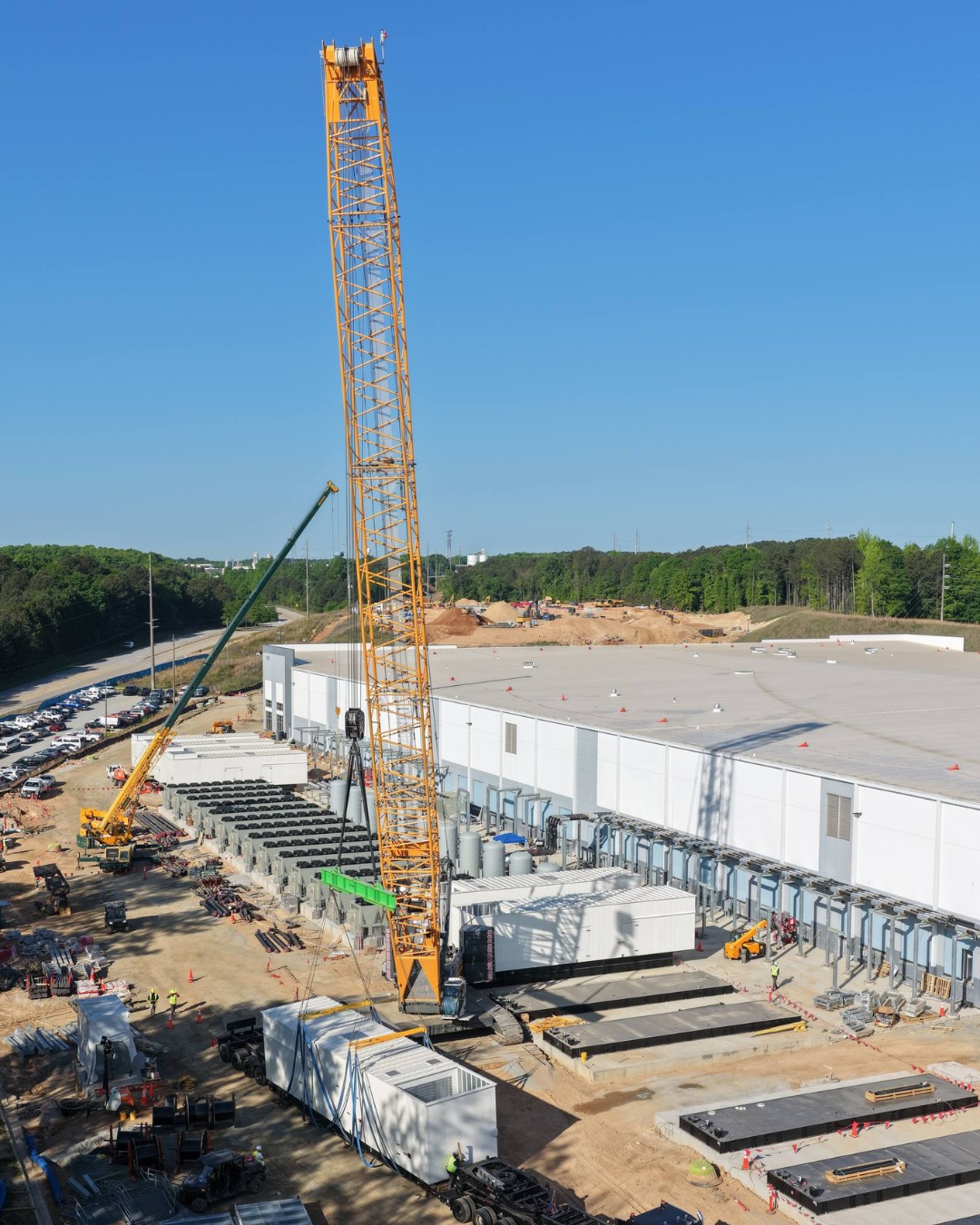 Large Generac generators in white enclosures are installed at a data center construction site