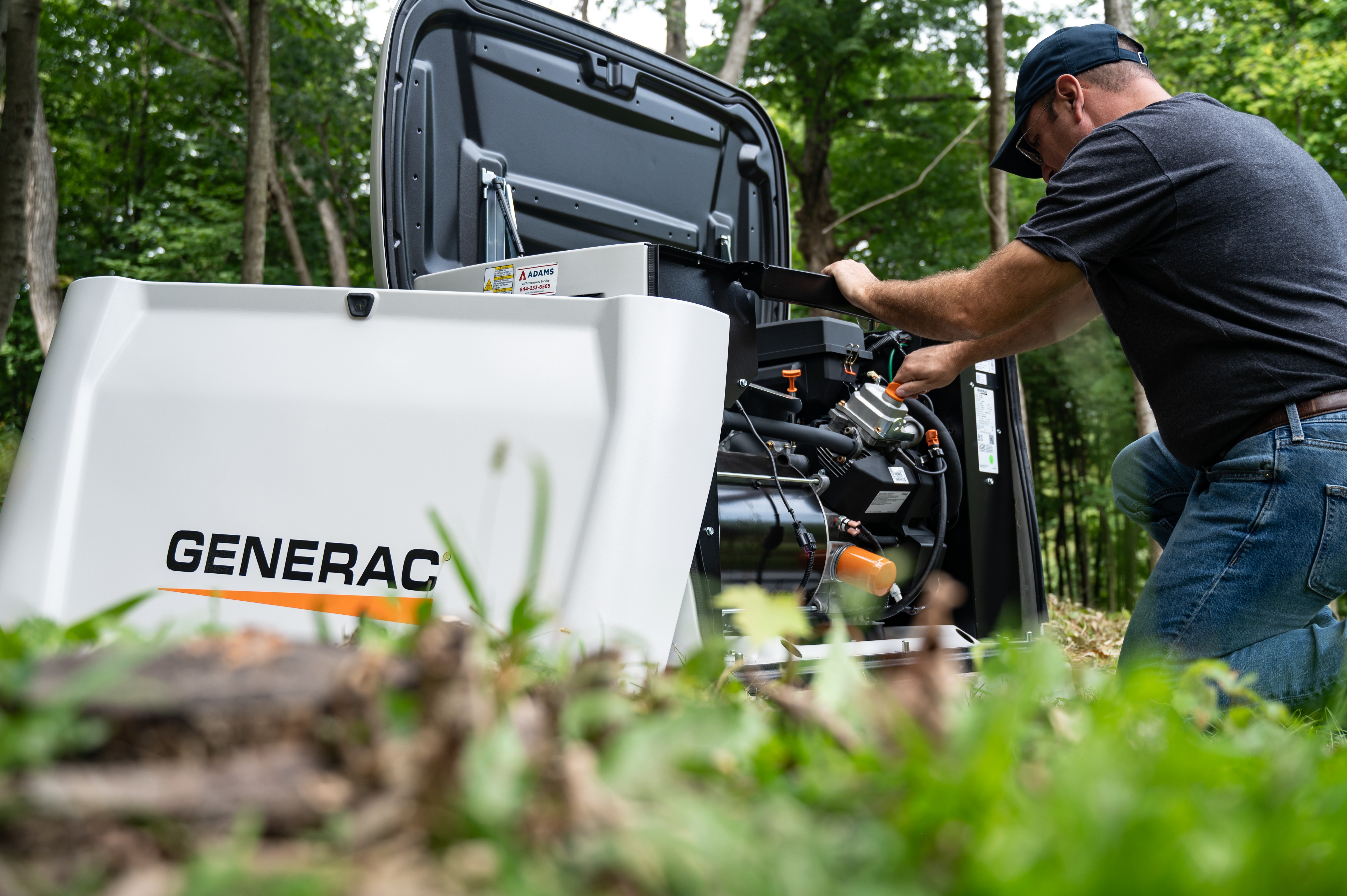  A technician performs maintenance on a Generac home standby generator