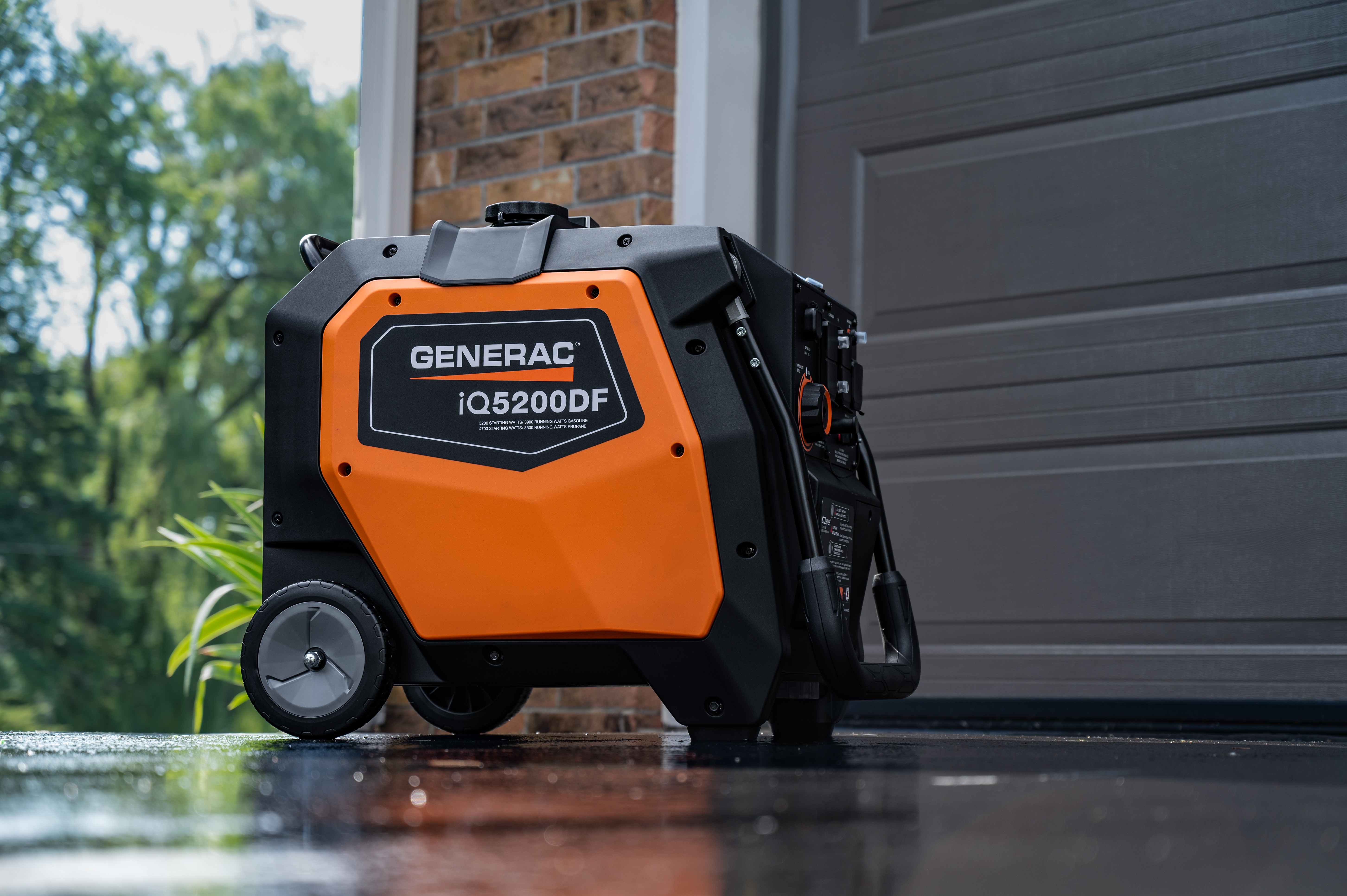 A black and orange Generac power station sits in a driveway