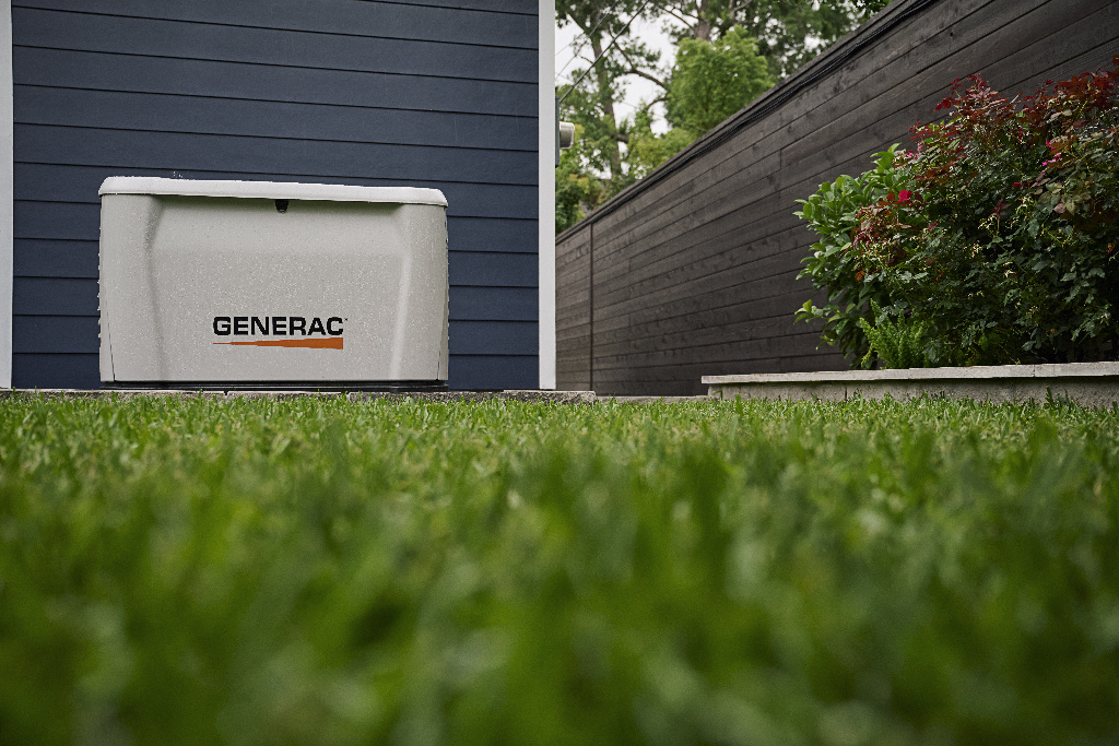 Image of a Generac home standby generator next to the siding of a house