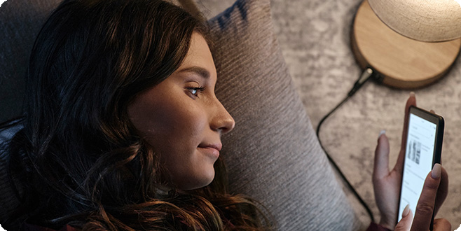 woman looking at phone on couch